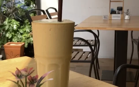 Protein shake on an outdoor table at Poached Rawai Beach, Phuket, Thailand. Breakfast near Rawai.