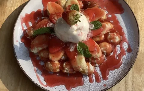 Strawberry Waffles in the sunlight with an ice-cream scoop on top at Poached Rawai Beach, Phuket, Thailand, the best Rawai restaurant.