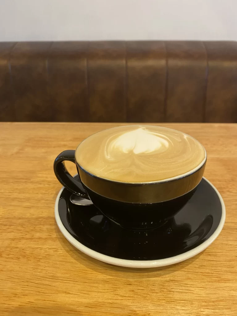 Hot Latte on a table at Poached Breakfast Cafe Rawai, Phuket, Thailand. The best food in Rawai? It's right here!