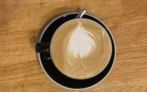 Overhead view of a latte at Poached Breakfast Cafe Rawai, Phuket, Thailand. Best takeout coffee in Rawai