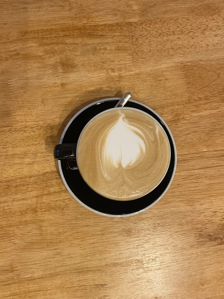 Overhead view of a latte at Poached Breakfast Cafe Rawai, Phuket, Thailand. Best takeout coffee in Rawai