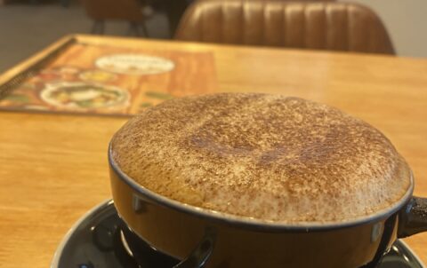 Fluffy cappuccino on a table early in the morning at Poached Breakfast Cafe Rawai, Phuket, Thailand. It's the best iced coffee in Rawai!