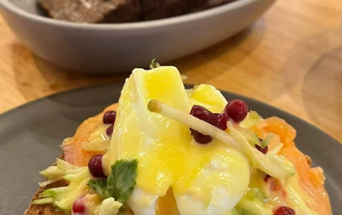 In the foreground you can see eggs benedict and in the background you can see banana bread at the best healthy restaurant in Rawai, Poached Breakfast Cafe, Rawai, Phuket, Thailand