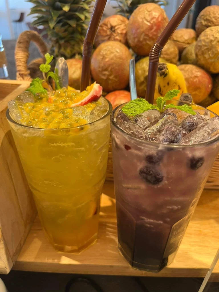 Passionfruit Italian Soda and Blueberry Italian Soda on the counter at Poached Breakfast Cafe Rawai, Phuket, Thailand. Our cafe serves the best iced coffee in Rawai!