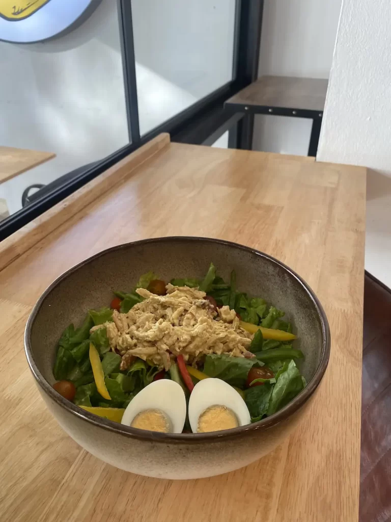 Chicken Curry Salad on our bar seating that overlooks the ocean. This is what makes Poached one of the top things to do in Rawai at Poached Breakfast Cafe Rawai, Phuket, Thailand