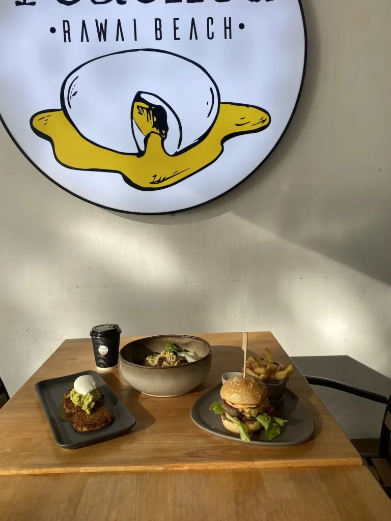 Fritters with poached eggs, chicken salad and a burger in the morning light at the answer to the question, where to go in Nai Harn: Poached Breakfast Cafe Rawai, Phuket, Thailand