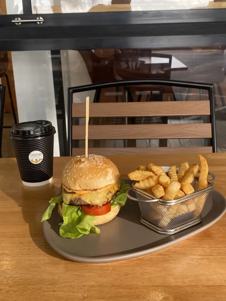 One of the best tourist attractions in Naiharn might just be this burger and french fries with a coffee in the sunshine at Poached Breakfast Cafe Rawai, Phuket, Thailand