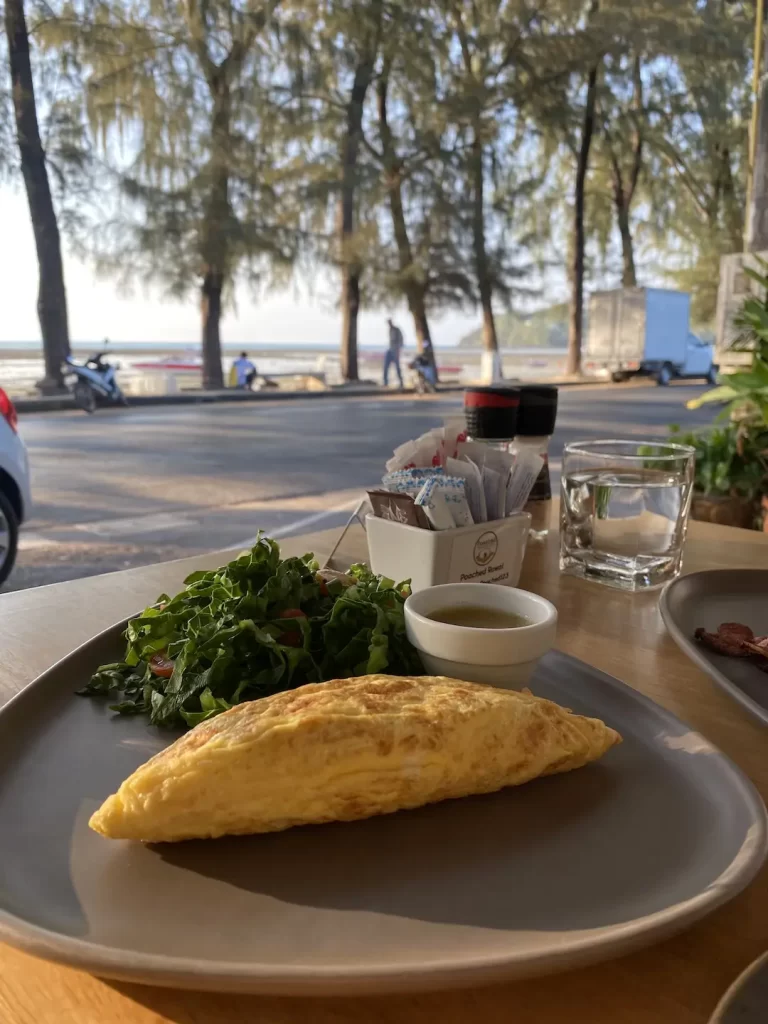 Breakfast omelette with salad on the beachfront of Rawai at the place with the best cafe culture in Nai Harn: Poached Breakfast Cafe Rawai, Phuket, Thailand