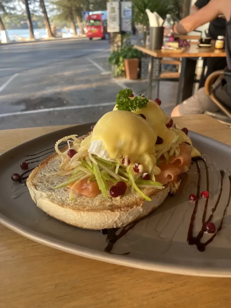 Smoked Salmon Eggs Benedict on the beach make for the perfect breakfast before you head off to a beach club in Rawai. Only at Poached Breakfast Cafe Rawai, Phuket, Thailand.