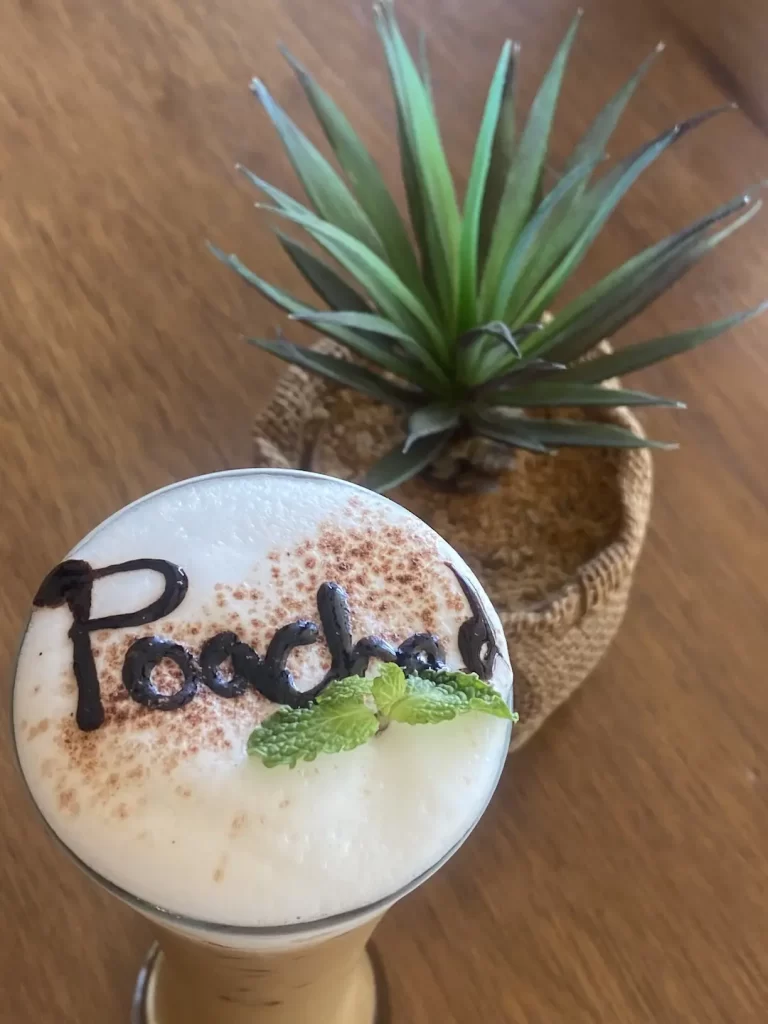 Our after eight iced cappuccino with the word 'Poached' written in chocolate syrup on top. We serve the best specialty coffee in Rawai at Poached Breakfast Cafe, Rawai, Phuket, Thailand