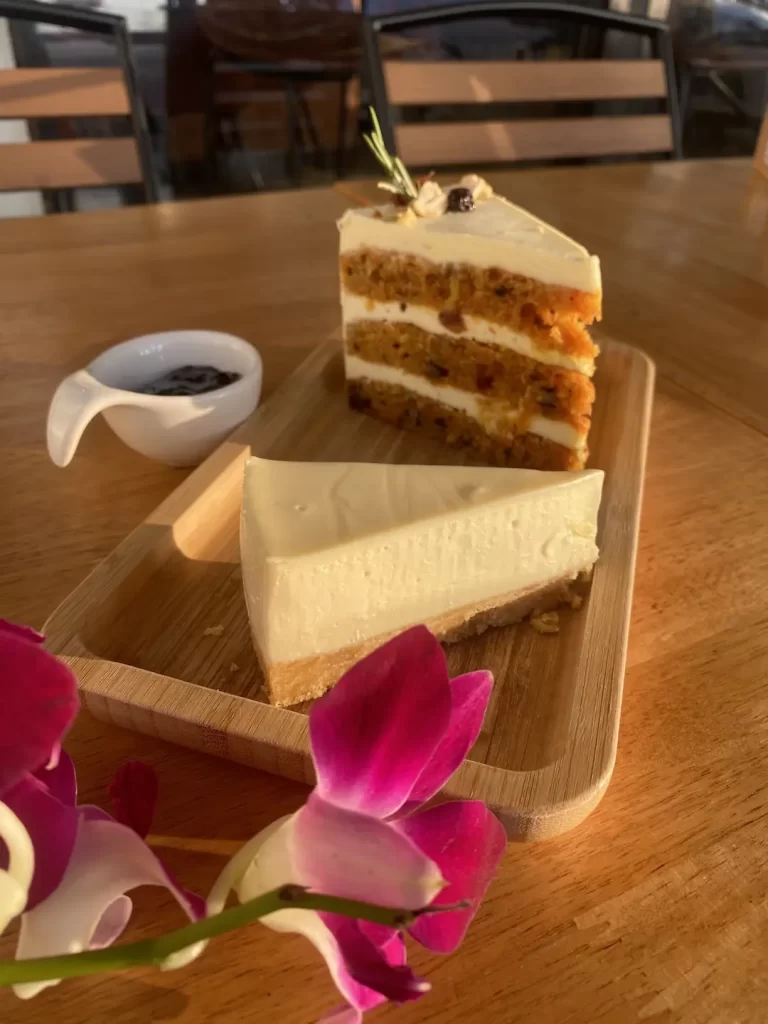 Carrot cake and a cheesecake with a small bowl of blueberry jam. The best dessert in Rawai at Poached Breakfast Cafe Rawai, Phuket, Thailand