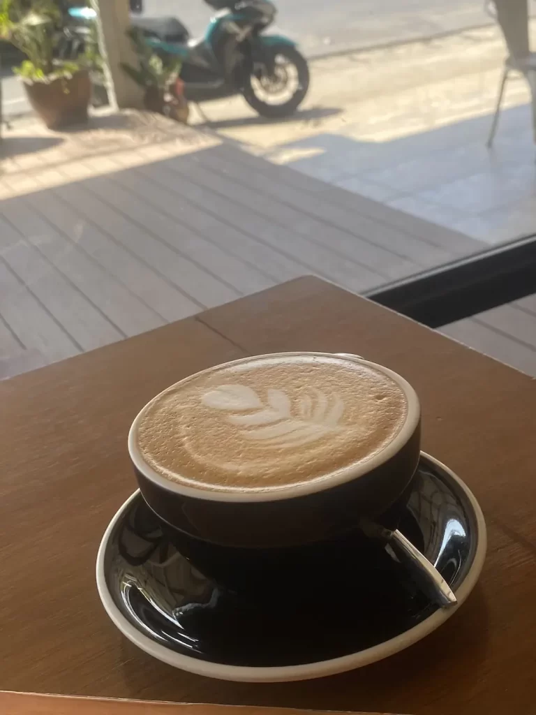 Delicious latte outdoors in the shade with coffee art. A great alternate to a smoothie near Rawai. Only at Poached Breakfast Cafe, Rawai, Phuket, Thailand