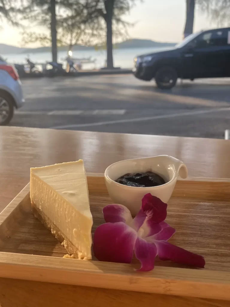 Cheese cake with blueberry jam and an orchid at the spot with the best apple pie near Nai Harn: Poached Breakfast Cafe Rawai, Phuket, Thailand