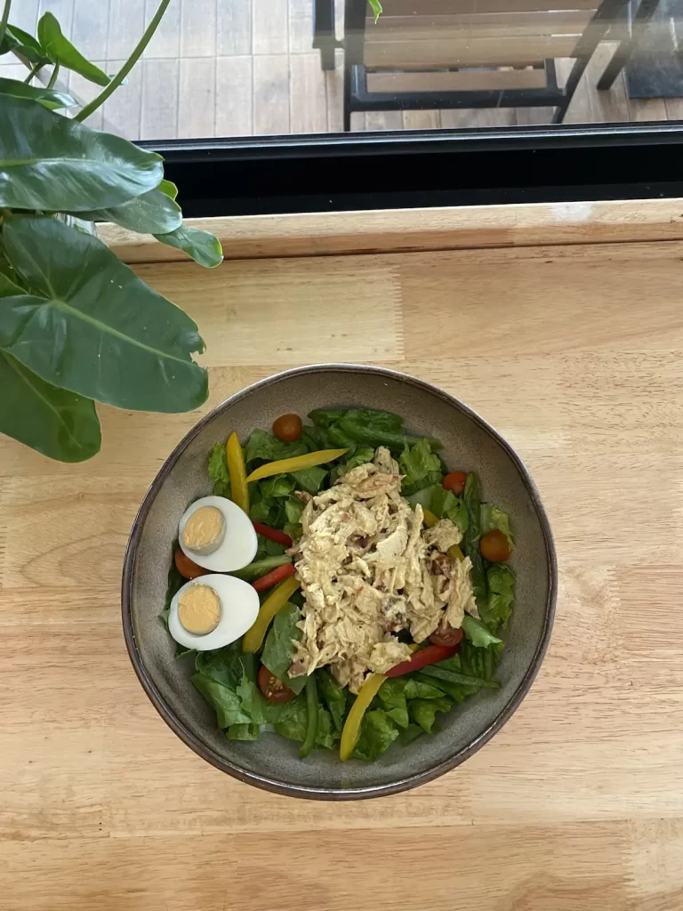Pulled curried chicken salad with a boiled egg. This is the perfect meal after visiting one of the great gyms near Nai Harn. Only at Poached Breakfast Cafe, Rawai, Phuket, Thailand