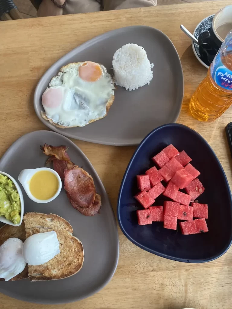 Fruit, rice, eggs, avocado, bacon and watermelon at Poached Breakfast Cafe Rawai: a fantastic breakfast before heading out on one of the island tours in Rawai.