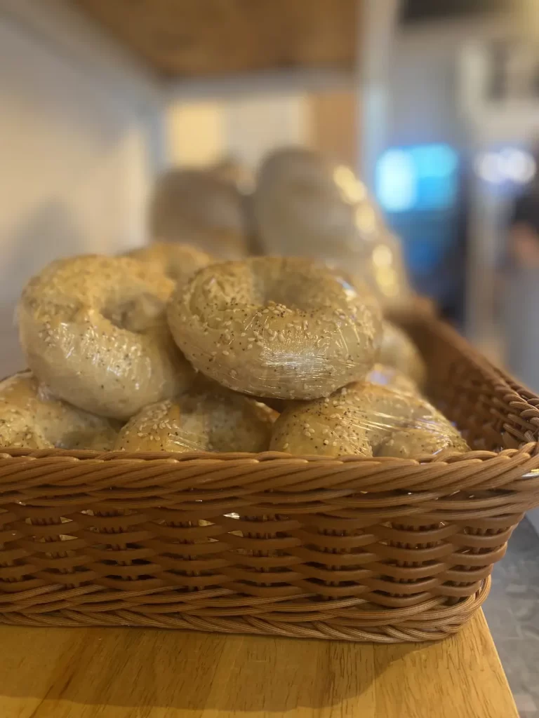 A basket of freshly baked bagels. All at the best place to eat when you're staying at one of the hostels in Rawai: Poached Breakfast Cafe Rawai, Phuket, Thailand