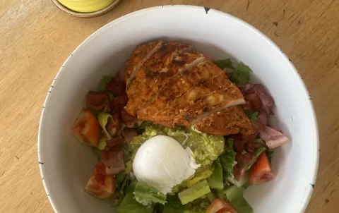 Chicken Cobb salad with avocado, egg and bacon next to a cactus at the top local cafe near Nai Harn: Poached Breakfast Cafe Rawai, Phuket, Thailand