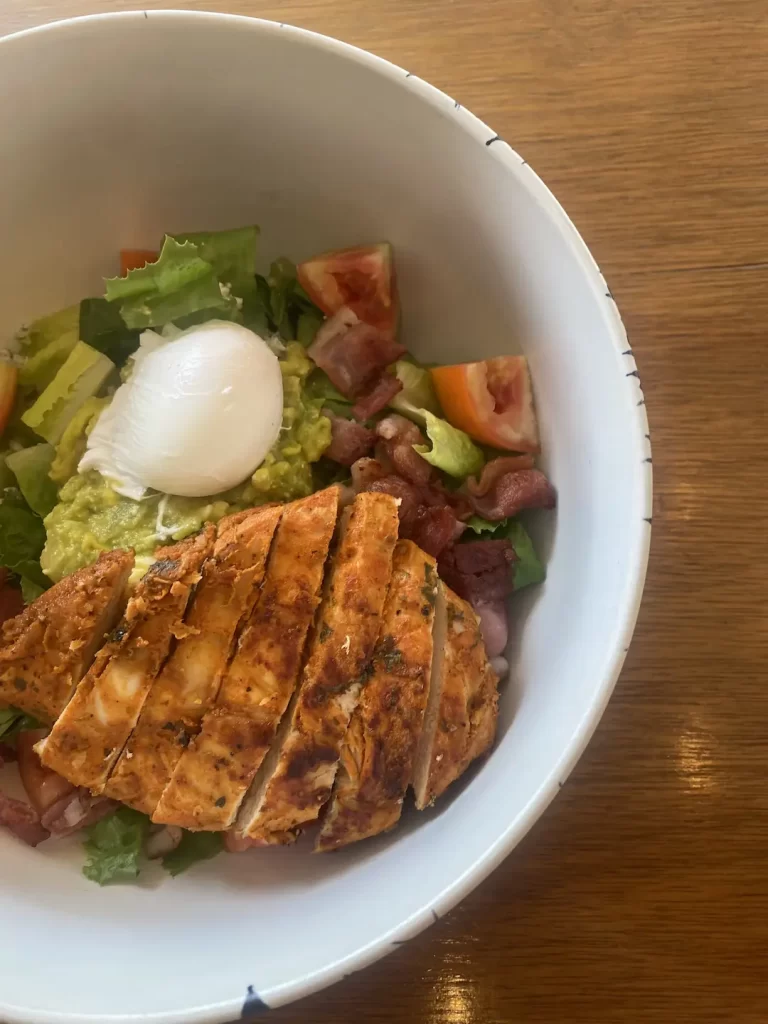 Close up of a chicken cobb salad at the cafe to eat at before you head out on one of the great routes to run in Nai Harn: Poached Breakfast Cafe, Phuket, Thailand