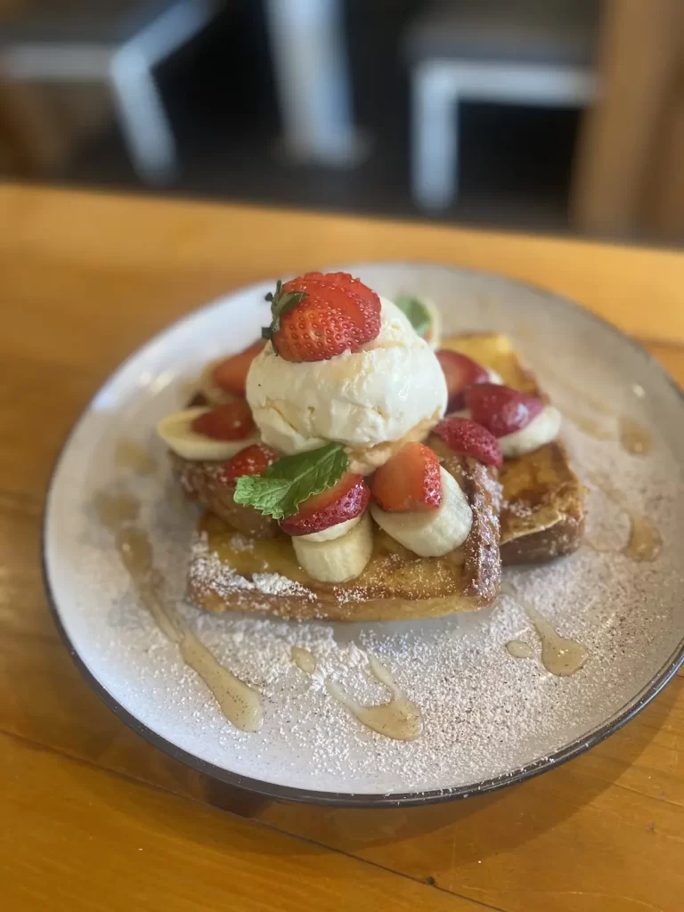 French toast with bananas, ice cream and strawberries at the cafe to eat at before you head out on one of the great routes to run in Nai Harn: Poached Breakfast Cafe, Phuket, Thailand