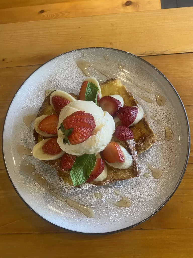 French Toast with banana, ice cream and strawberries at the spot to eat at before visiting the best viewpoints near Nai Harn: Poached Breakfast Cafe Rawai, Phuket, Thailand