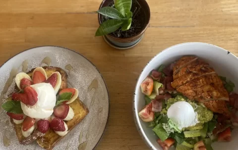 French toast stack with strawberries, banana and an ice cream scoop on the right. A bowl of chicken cobb salad with smashed avocado, poached egg, bacon bits and blue cheese dressing. This is a great place to eat before checking out spots for motorbike hire in Rawai. Only at Poached Breakfast Cafe Rawai, Phuket, Thailand